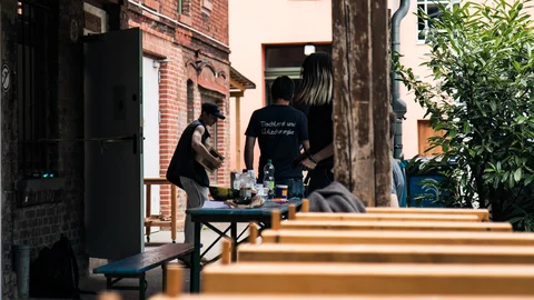 Drei Personen vor der Werkstatt