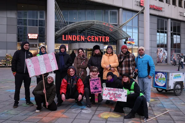 Gruppe von Aktivisten mit Schildern ('Wir sind für Frieden', 'Fight Racism', 'Wir sind Mehr') vor dem Linden-Center.